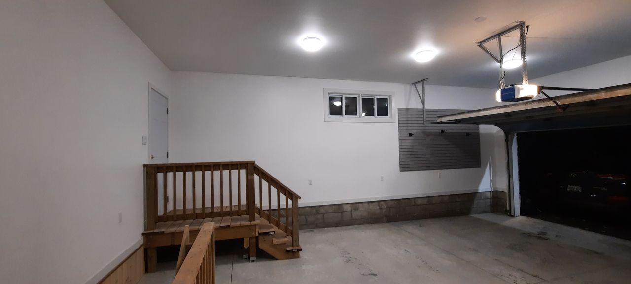 A cedar stair rail and landing built inside a finished Ottawa garage